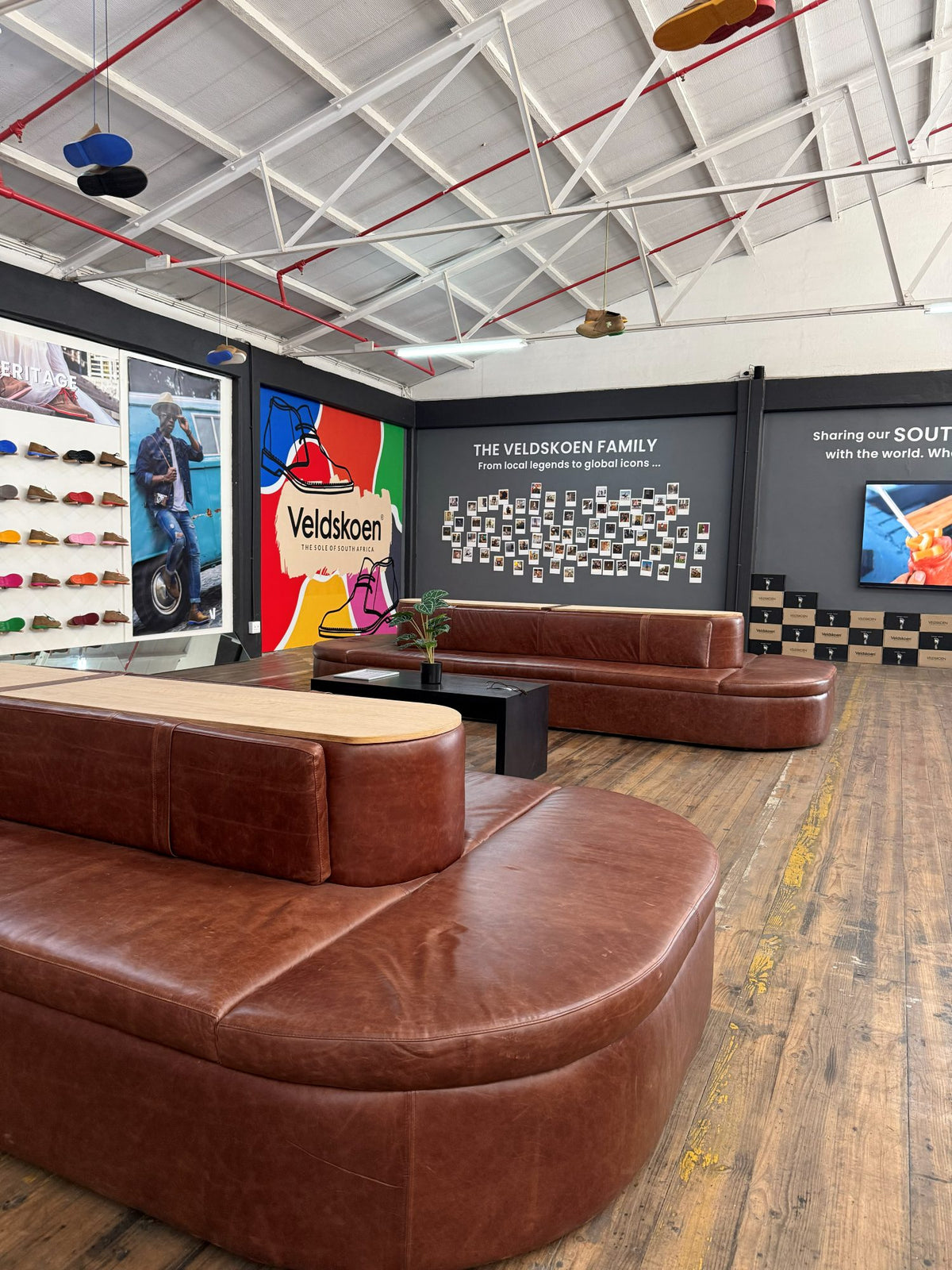 A leather sofa in front of the colour mural and the Veldskoen® family wall